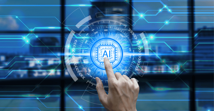 Picture of a human hand with the index finger touching a holographic-like image that says 