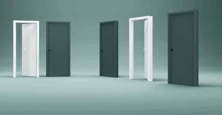 A photo of three open doors in an empty room
