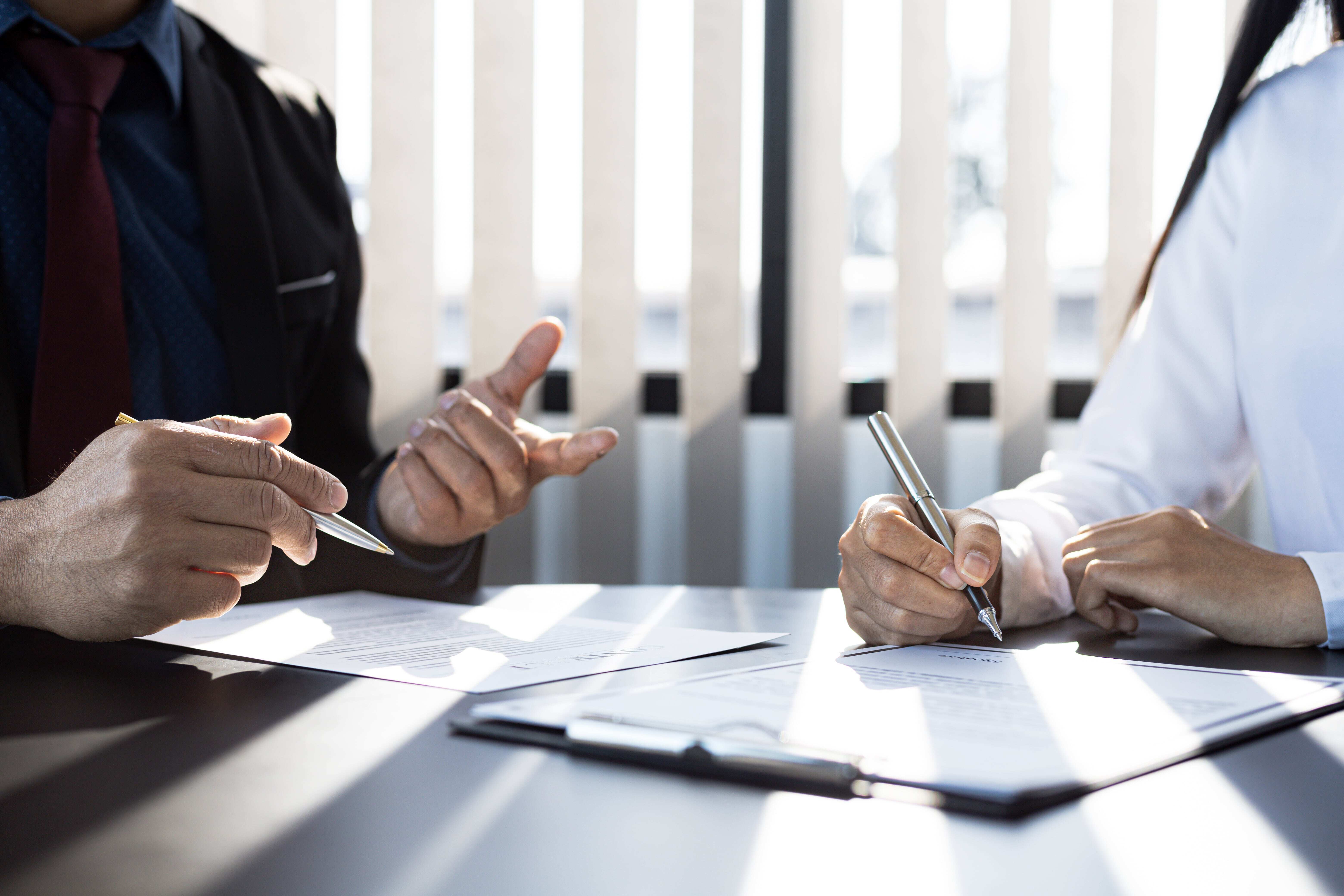 FSO two men workinig on paperwork -min