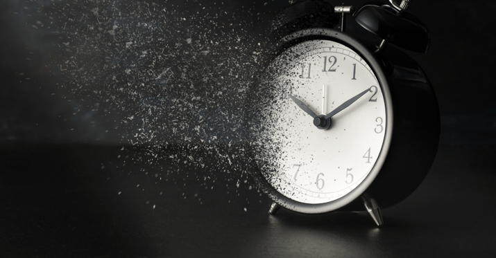 Image of an alarm clock fading away into dust.
