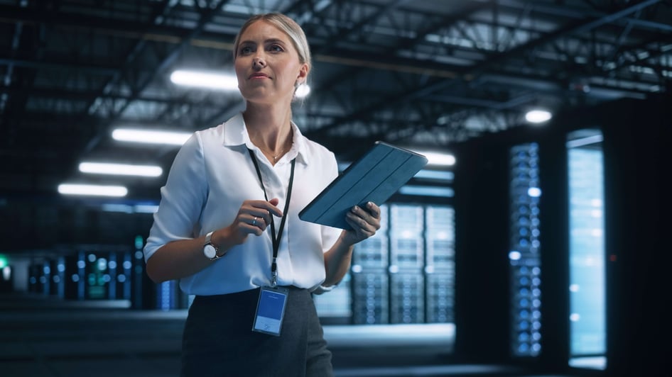 Woman in a server room with an ipad